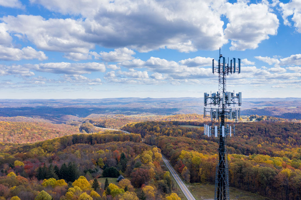 Aerial view of a mobile service tower in forested area of West Virginia.